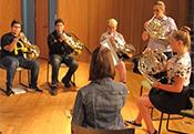 music students playing french horns for concert